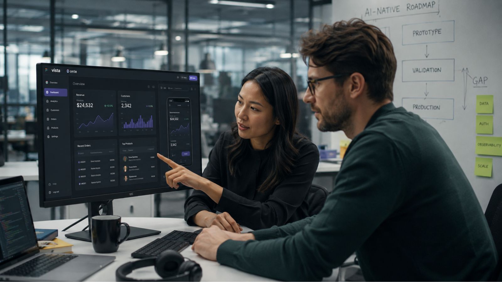Product manager and developer reviewing an AI-generated software prototype on a laptop in a calm modern office